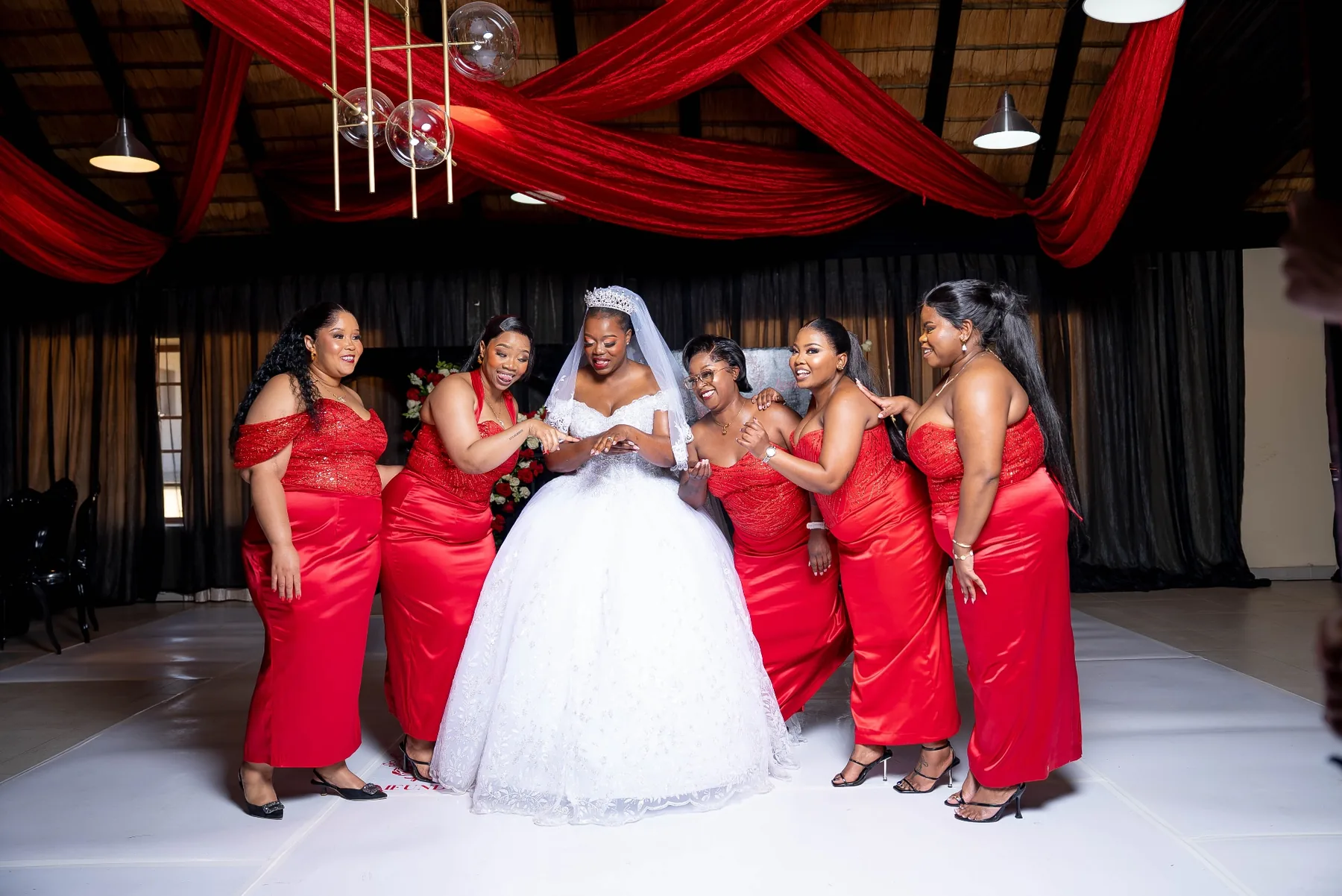 Bride and Bridesmaids at a Red and Black Wedding Reception